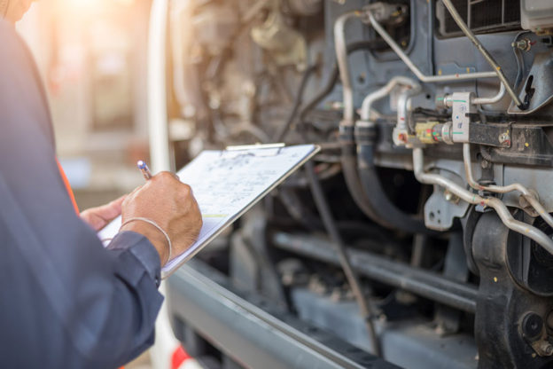 driver going through commercial truck maintenance checklist