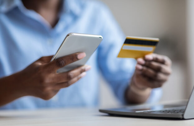 Man holding phone and credit card