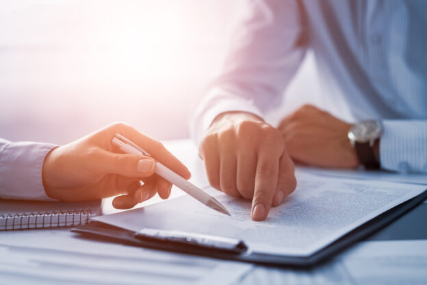 Two people signing contract