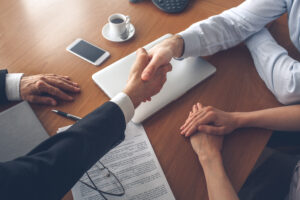 two people shake hands after conducting business, successfully avoiding double brokering