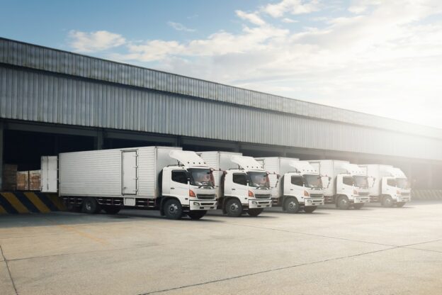 Freight trucks parked at a warehouse.